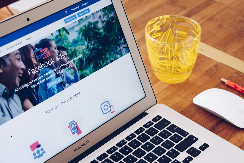 un computer pe birou cu reclame pe Facebook