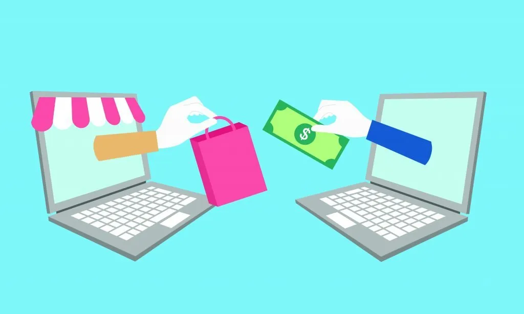 Un'illustrazione di due laptop che illustrano DTC. Una mano si allunga da un laptop con una borsa della spesa. A aveva allungato una mano dall'altro laptop con una banconota da un dollaro.