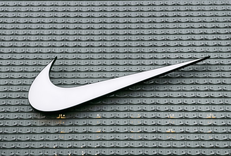 logo Nike alb pe partea laterală a clădirii gri