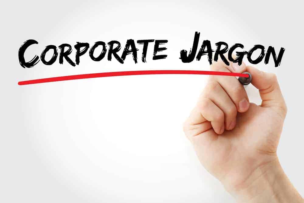Une main surlignant le mot "Corporate Jargon" avec un marqueur rouge.