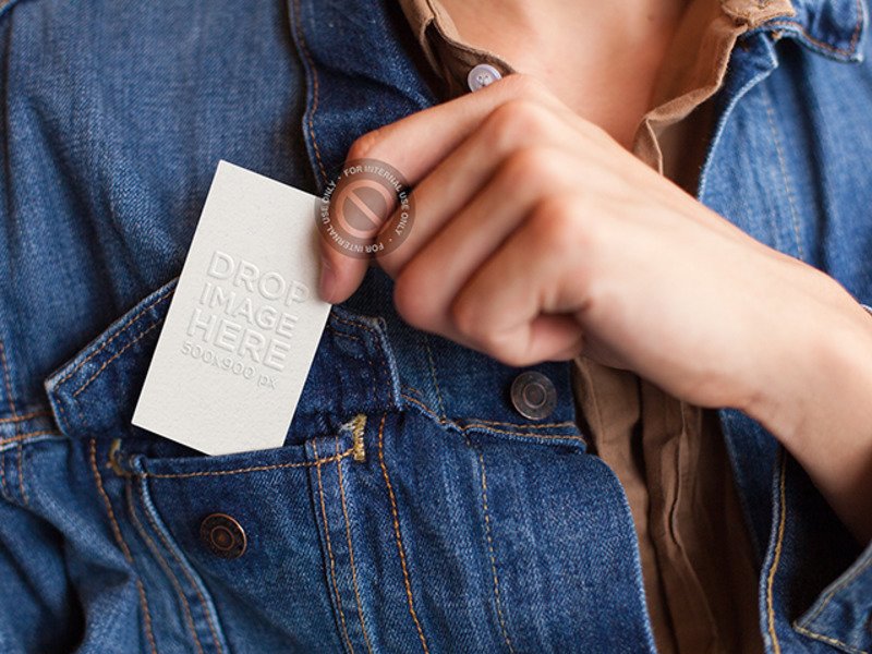 MOCKUP OF A WOMAN PLACING A BUSINESS CARD IN HER JACKET'S FRONT POCKET