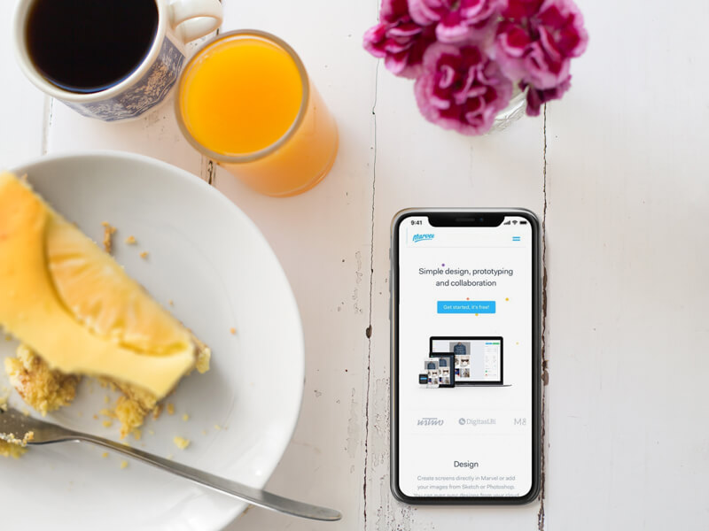 Мокап iPhone X, лежащий рядом с тарелкой с чизкейком