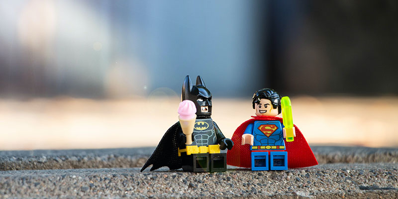縁石に置かれたバットマンとスーパーマンのレゴ